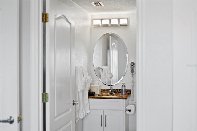 12000 Gulf Blvd Unit 506N, Treasure Island, FL 33706 - bathroom with vanity and a textured ceiling