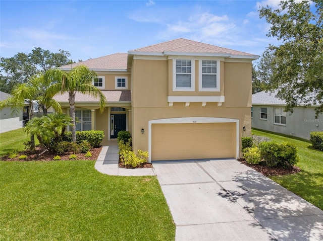 5015 58th Ter E, Bradenton, FL 34203 - traditional-style house with an attached garage, stucco siding, driveway, and a front lawn