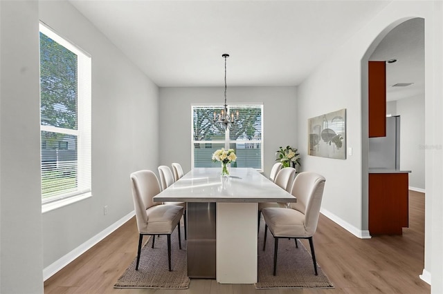 5015 58th Ter E, Bradenton, FL 34203 - dining space with healthy amount of natural light, light wood-style floors, arched walkways, and a chandelier