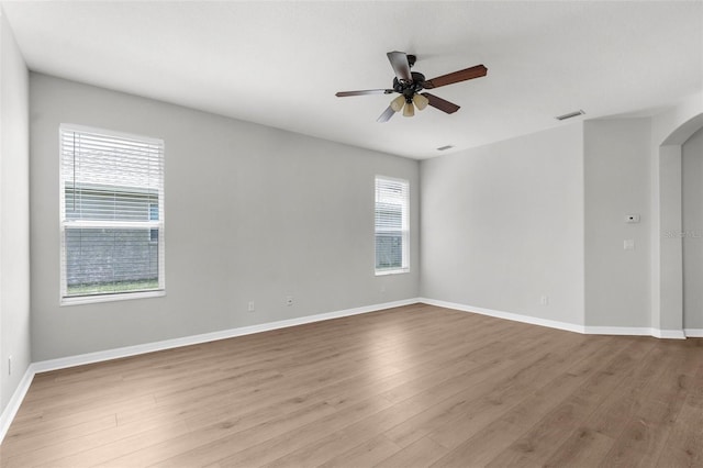 5015 58th Ter E, Bradenton, FL 34203 - empty room with arched walkways, wood finished floors, and a ceiling fan