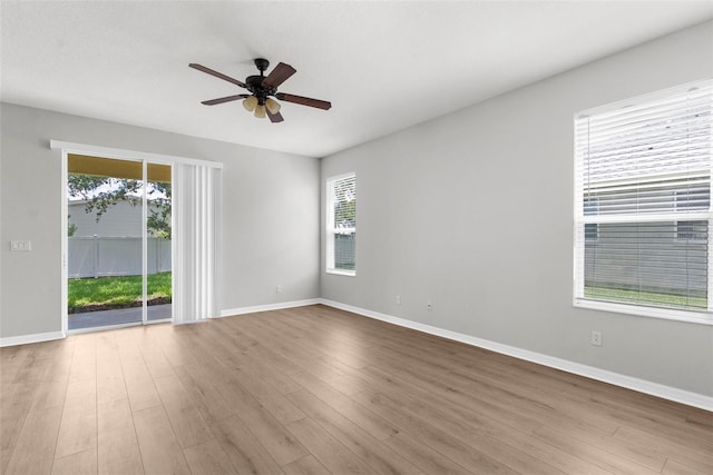 5015 58th Ter E, Bradenton, FL 34203 - empty room featuring healthy amount of natural light, a ceiling fan, and wood finished floors