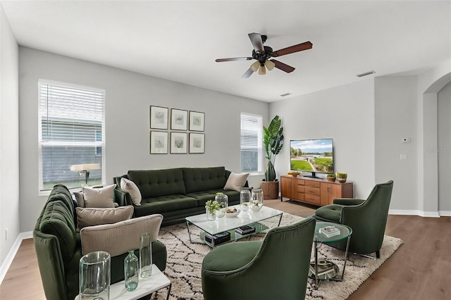 5015 58th Ter E, Bradenton, FL 34203 - living area with arched walkways, a ceiling fan, healthy amount of natural light, and light wood-type flooring