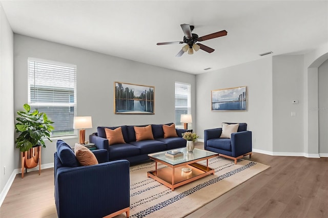 5015 58th Ter E, Bradenton, FL 34203 - living room featuring light wood-style floors, arched walkways, and a ceiling fan