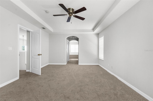 5015 58th Ter E, Bradenton, FL 34203 - spare room with a tray ceiling, a ceiling fan, arched walkways, and carpet