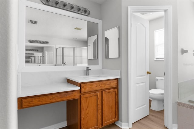 5015 58th Ter E, Bradenton, FL 34203 - bathroom with vanity, a shower stall, and wood finished floors