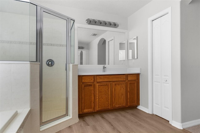 5015 58th Ter E, Bradenton, FL 34203 - full bath featuring a shower stall, wood finished floors, vanity, a closet, and a bath