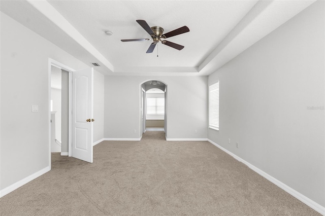 5015 58th Ter E, Bradenton, FL 34203 - carpeted empty room with a raised ceiling, a ceiling fan, arched walkways, and a smoke detector