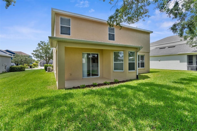 5015 58th Ter E, Bradenton, FL 34203 - rear view of house with stucco siding and a yard