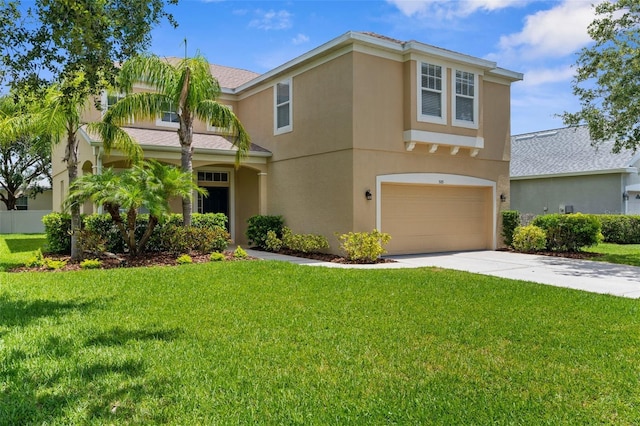 5015 58th Ter E, Bradenton, FL 34203 - view of front of home featuring an attached garage, stucco siding, concrete driveway, and a front yard