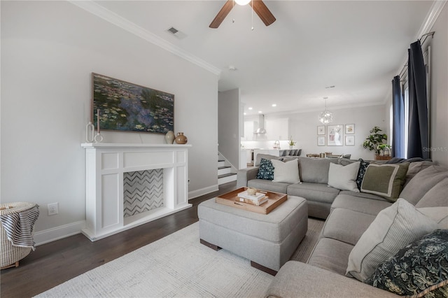 403 S Fremont Ave Unit 3, Tampa, FL 33606 - living area with dark wood-style floors, a ceiling fan, crown molding, a chandelier, and stairs