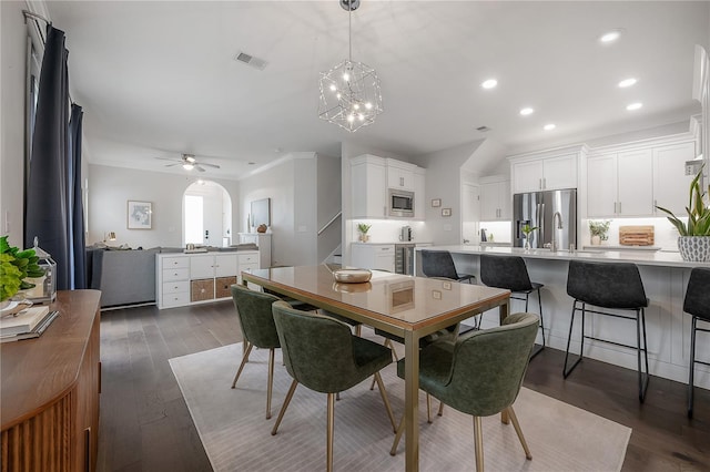 403 S Fremont Ave Unit 3, Tampa, FL 33606 - dining area featuring arched walkways, recessed lighting, a chandelier, dark wood-type flooring, and a ceiling fan