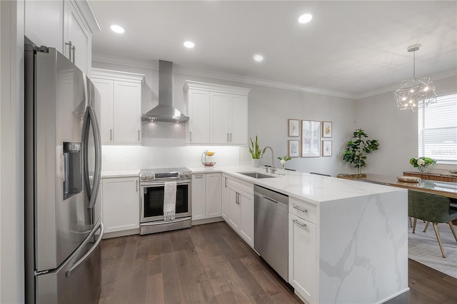 403 S Fremont Ave Unit 3, Tampa, FL 33606 - kitchen with appliances with stainless steel finishes, wall chimney exhaust hood, a peninsula, backsplash, and white cabinetry