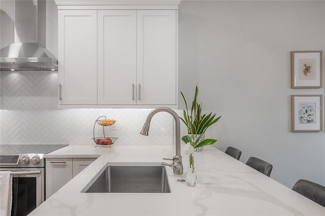 403 S Fremont Ave Unit 3, Tampa, FL 33606 - kitchen with wall chimney range hood, electric stove, decorative backsplash, and light stone countertops