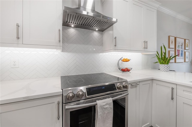 403 S Fremont Ave Unit 3, Tampa, FL 33606 - kitchen featuring electric stove, wall chimney exhaust hood, white cabinetry, ornamental molding, and decorative backsplash