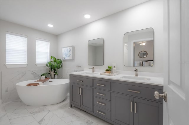 403 S Fremont Ave Unit 3, Tampa, FL 33606 - full bathroom with double vanity, a freestanding bath, marble look tiles, and recessed lighting