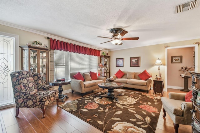 9548 141st St, Seminole, FL 33776 - living room with ceiling fan, a textured ceiling, ornamental molding, and wood finished floors