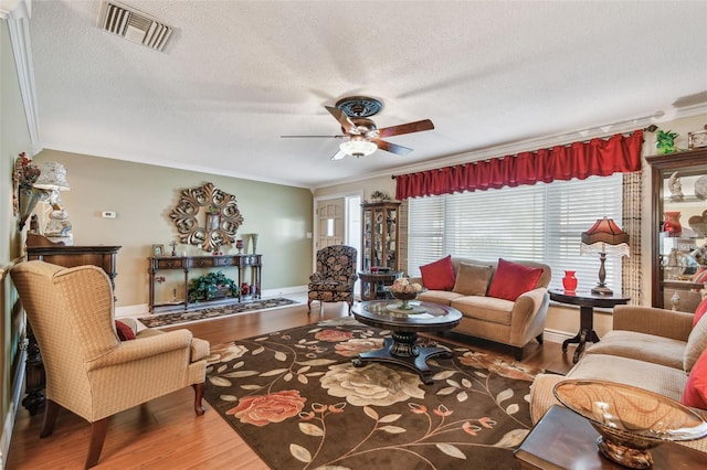 9548 141st St, Seminole, FL 33776 - living area with a textured ceiling, a ceiling fan, wood finished floors, and crown molding