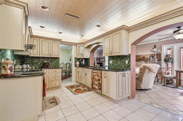 9548 141st St, Seminole, FL 33776 - kitchen with cream cabinets, arched walkways, ceiling fan, and ornamental molding