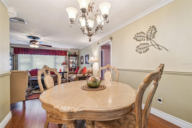 9548 141st St, Seminole, FL 33776 - dining area featuring a chandelier, wood finished floors, ornamental molding, ceiling fan, and a textured ceiling