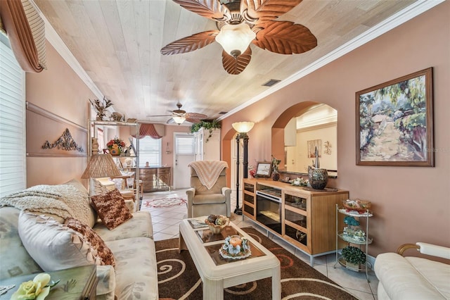 9548 141st St, Seminole, FL 33776 - living room with ceiling fan, tile patterned floors, crown molding, wooden ceiling, and arched walkways