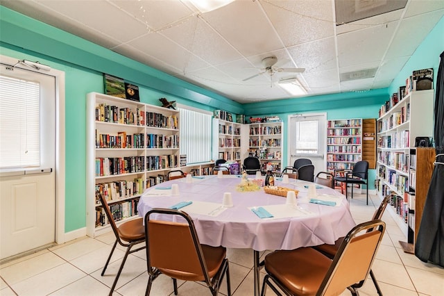 9548 141st St, Seminole, FL 33776 - dining area with a paneled ceiling, a ceiling fan, and light tile patterned flooring