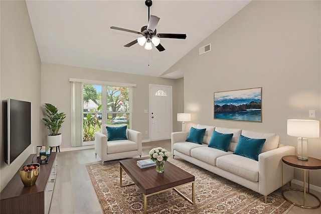 1621 Crossridge Dr, Brandon, FL 33510 - living room with light wood-style floors, ceiling fan, and high vaulted ceiling
