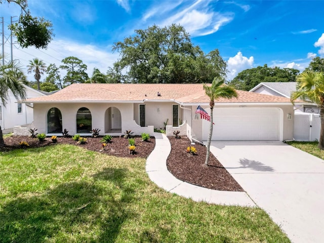 603 Ivey Ln, Tarpon Springs, FL 34689 - single story home featuring an attached garage, a front yard, driveway, and stucco siding