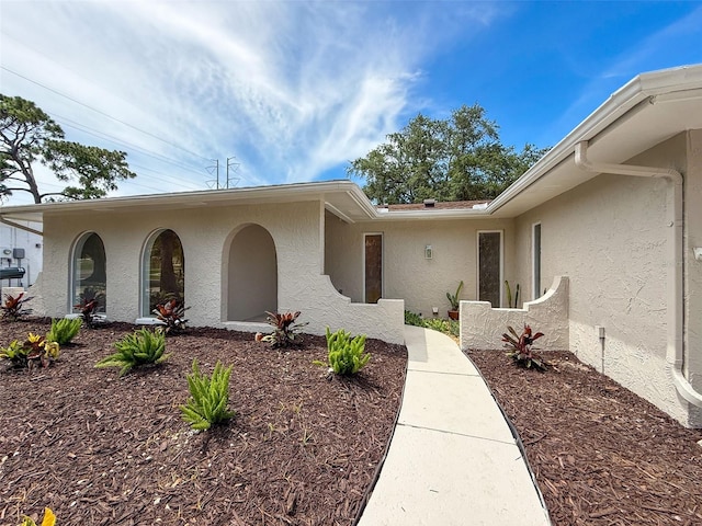 603 Ivey Ln, Tarpon Springs, FL 34689 - entrance to property featuring stucco siding