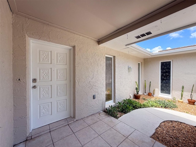 603 Ivey Ln, Tarpon Springs, FL 34689 - doorway to property with stucco siding