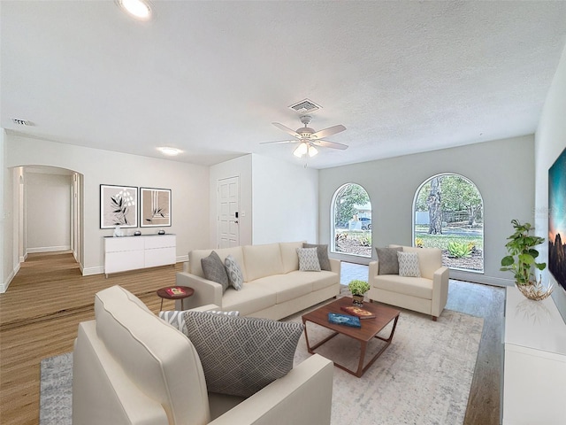 603 Ivey Ln, Tarpon Springs, FL 34689 - living area featuring light wood-style flooring, arched walkways, and ceiling fan