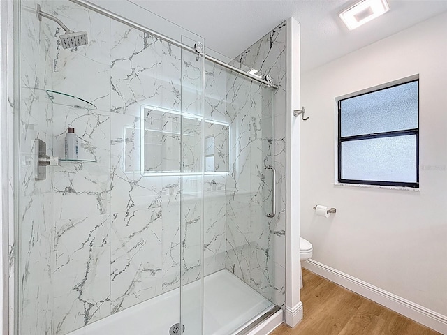 603 Ivey Ln, Tarpon Springs, FL 34689 - bathroom with a marble finish shower and wood finished floors