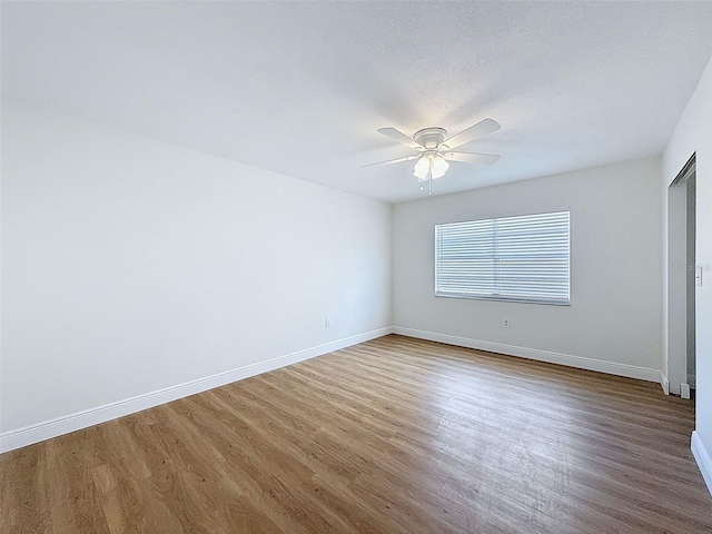 603 Ivey Ln, Tarpon Springs, FL 34689 - unfurnished bedroom with wood finished floors and ceiling fan