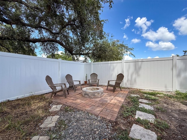 603 Ivey Ln, Tarpon Springs, FL 34689 - fenced backyard featuring a fire pit and a patio
