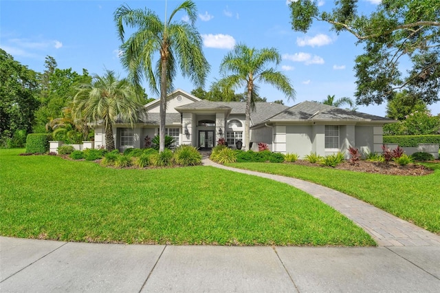 17311 Carriage Way, Odessa, FL 33556 - single story home featuring stucco siding, a front lawn, and french doors