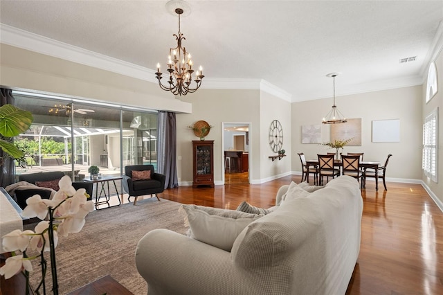 17311 Carriage Way, Odessa, FL 33556 - living room with a chandelier, wood finished floors, and ornamental molding