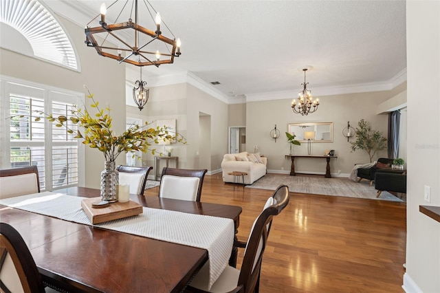 17311 Carriage Way, Odessa, FL 33556 - dining room with a chandelier, wood finished floors, and ornamental molding