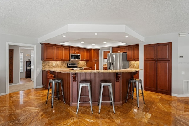 17311 Carriage Way, Odessa, FL 33556 - kitchen featuring appliances with stainless steel finishes, tasteful backsplash, light marble finish floors, recessed lighting, and a textured ceiling
