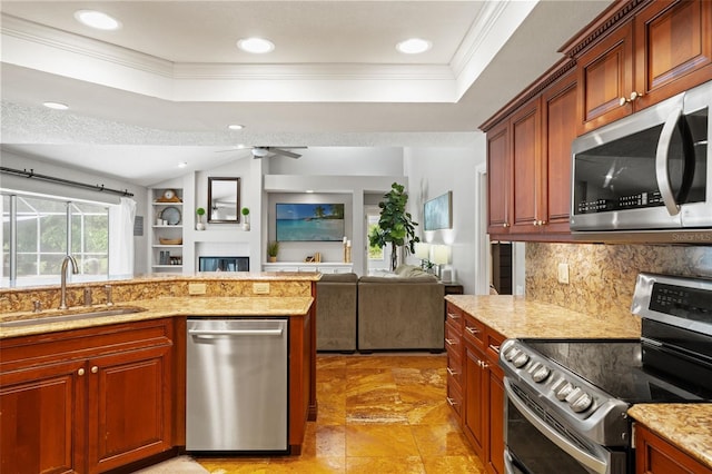17311 Carriage Way, Odessa, FL 33556 - kitchen with appliances with stainless steel finishes, a raised ceiling, crown molding, tasteful backsplash, and recessed lighting