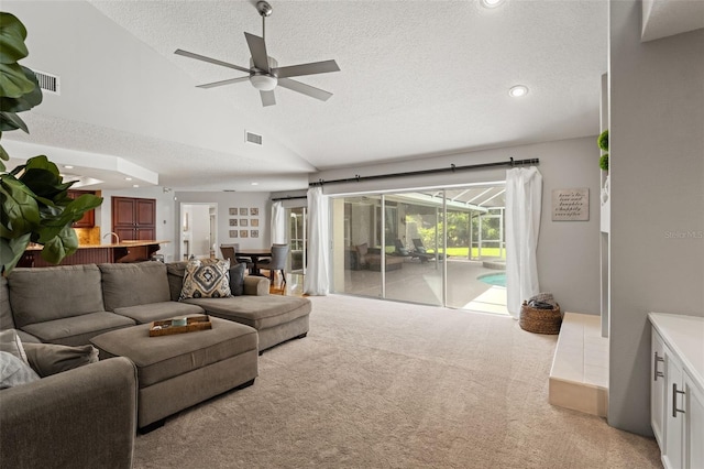 17311 Carriage Way, Odessa, FL 33556 - living room featuring a ceiling fan, lofted ceiling, a textured ceiling, light carpet, and recessed lighting