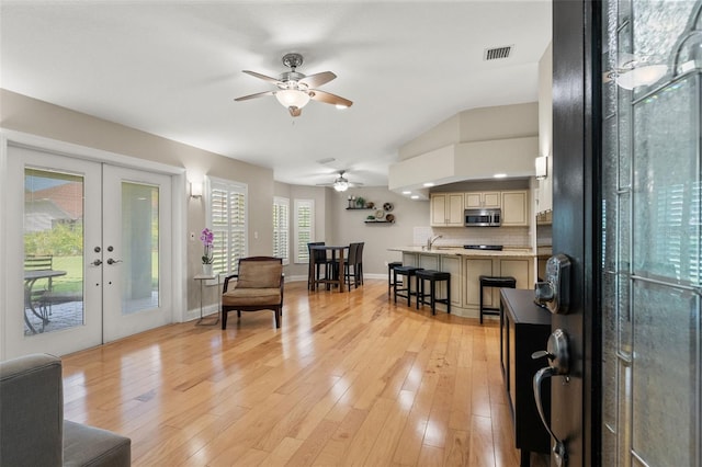 17311 Carriage Way, Odessa, FL 33556 - living room with a ceiling fan, french doors, and light wood finished floors