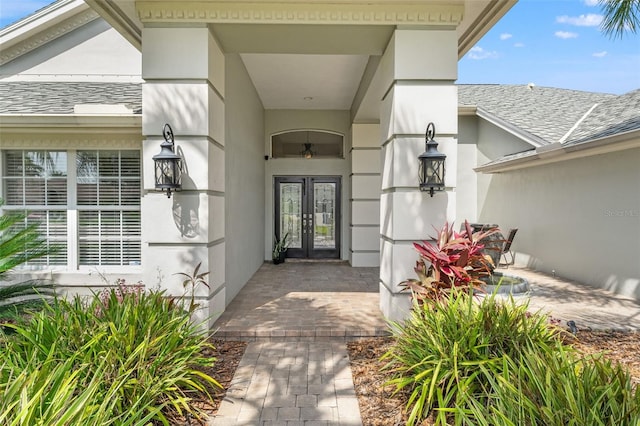 17311 Carriage Way, Odessa, FL 33556 - property entrance featuring french doors, a shingled roof, and stucco siding