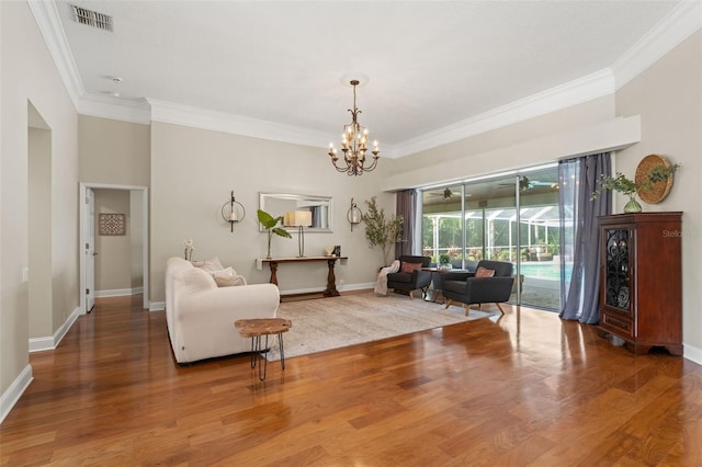 17311 Carriage Way, Odessa, FL 33556 - living room with crown molding, wood finished floors, and a chandelier