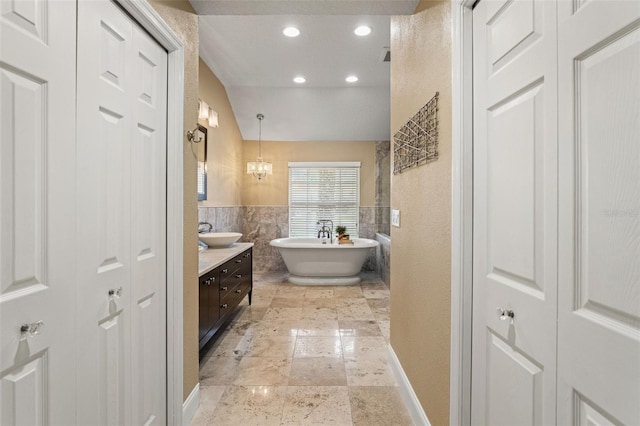 17311 Carriage Way, Odessa, FL 33556 - bathroom with vanity, tile walls, a closet, a soaking tub, and recessed lighting