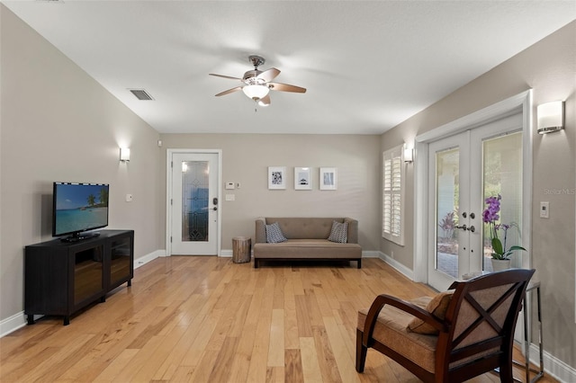 17311 Carriage Way, Odessa, FL 33556 - living area featuring french doors, light wood-style flooring, and a ceiling fan