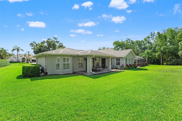 17311 Carriage Way, Odessa, FL 33556 - back of property with a lawn, stucco siding, and a patio area