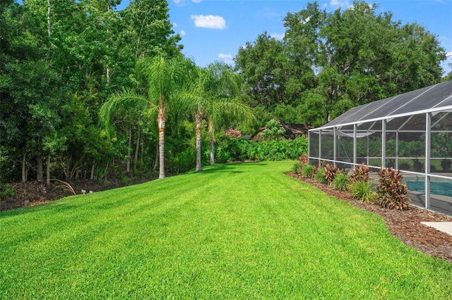 17311 Carriage Way, Odessa, FL 33556 - view of grassy yard with an outdoor pool and glass enclosure