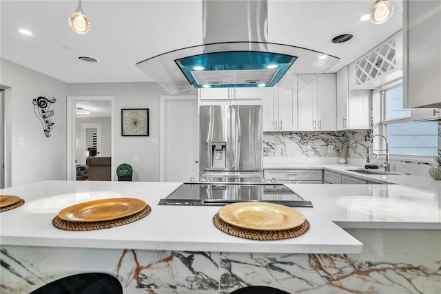 1384 S Hillcrest Ave, Clearwater, FL 33756 - kitchen with stainless steel refrigerator with ice dispenser, cooktop, backsplash, white cabinetry, and recessed lighting