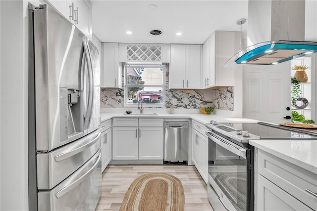 1384 S Hillcrest Ave, Clearwater, FL 33756 - kitchen featuring stainless steel appliances, island range hood, light wood-style flooring, white cabinetry, and recessed lighting