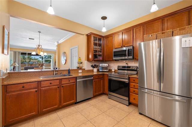 6677 84th Ave N, Pinellas Park, FL 33781 - kitchen with appliances with stainless steel finishes, brown cabinetry, light tile patterned flooring, glass insert cabinets, and tasteful backsplash