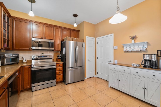 6677 84th Ave N, Pinellas Park, FL 33781 - kitchen featuring stainless steel appliances, glass insert cabinets, and pendant lighting